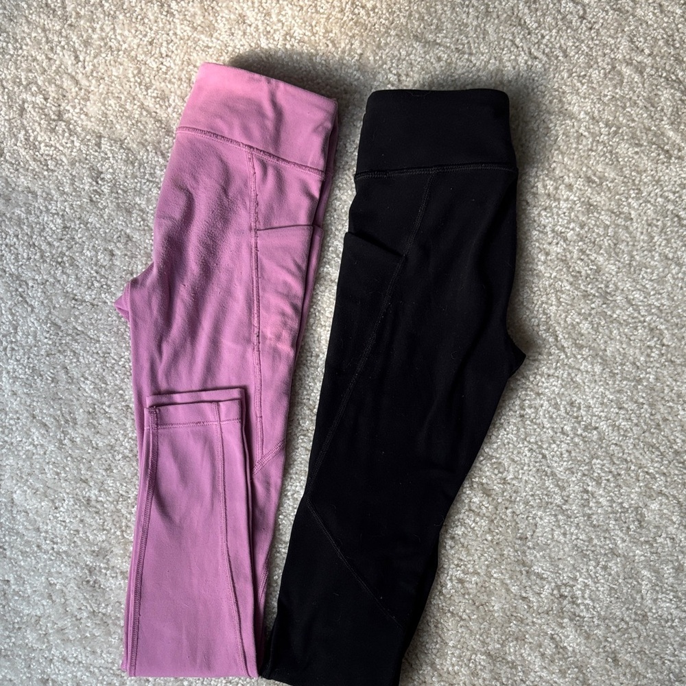 2 pairs of size 7 Athleta stash your treasure leggings